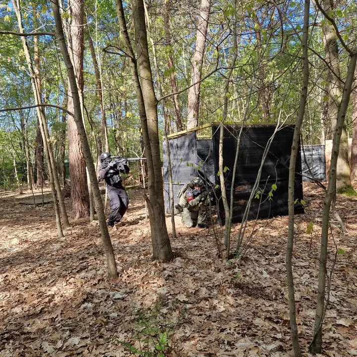 Spelers rukken op naar een afgeschermde stelling in het bos
